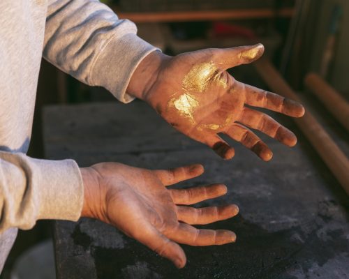 close-up-hands-with-golden-glitter